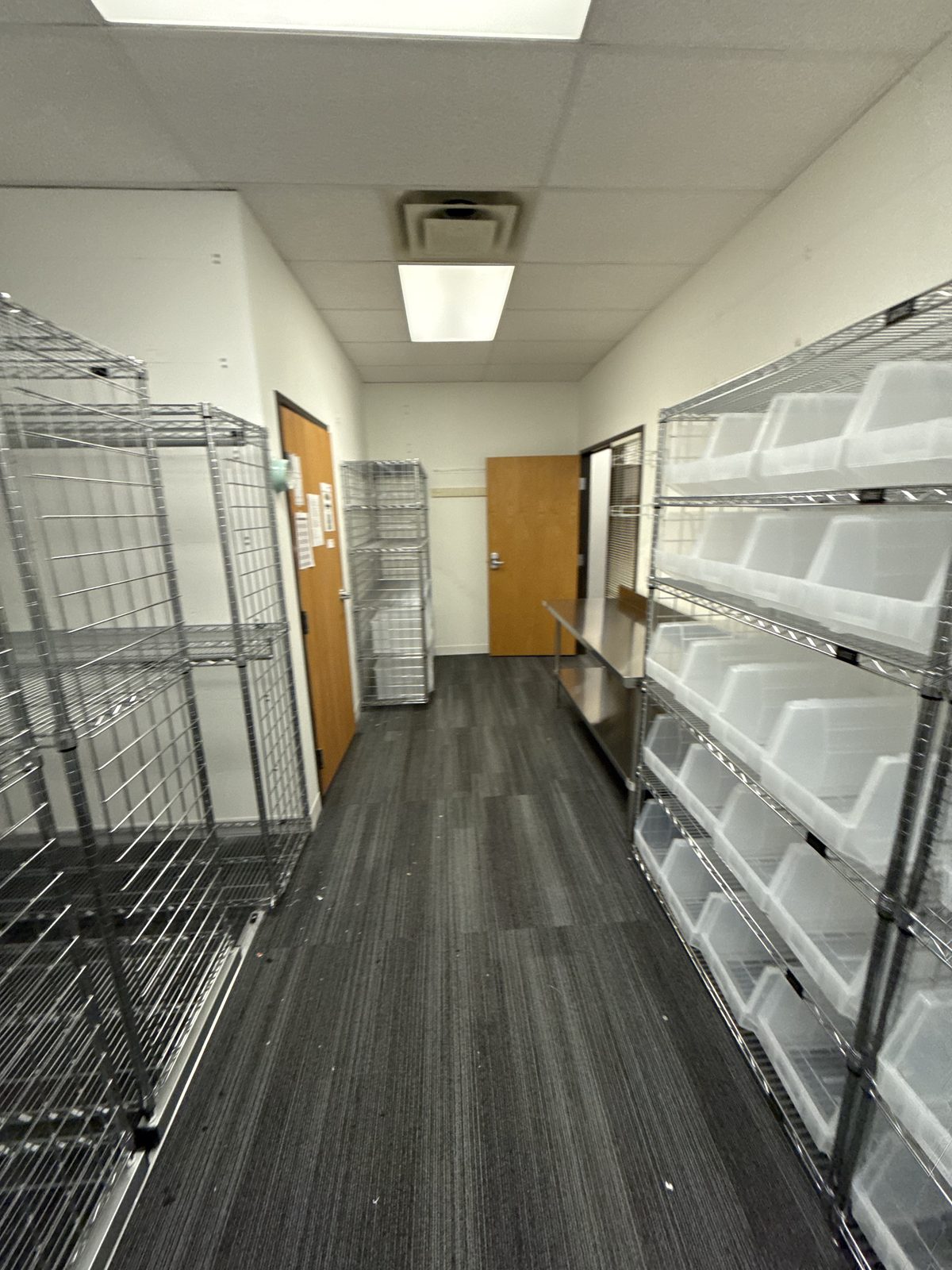 Stainless steel work table with storage bins and undershelf