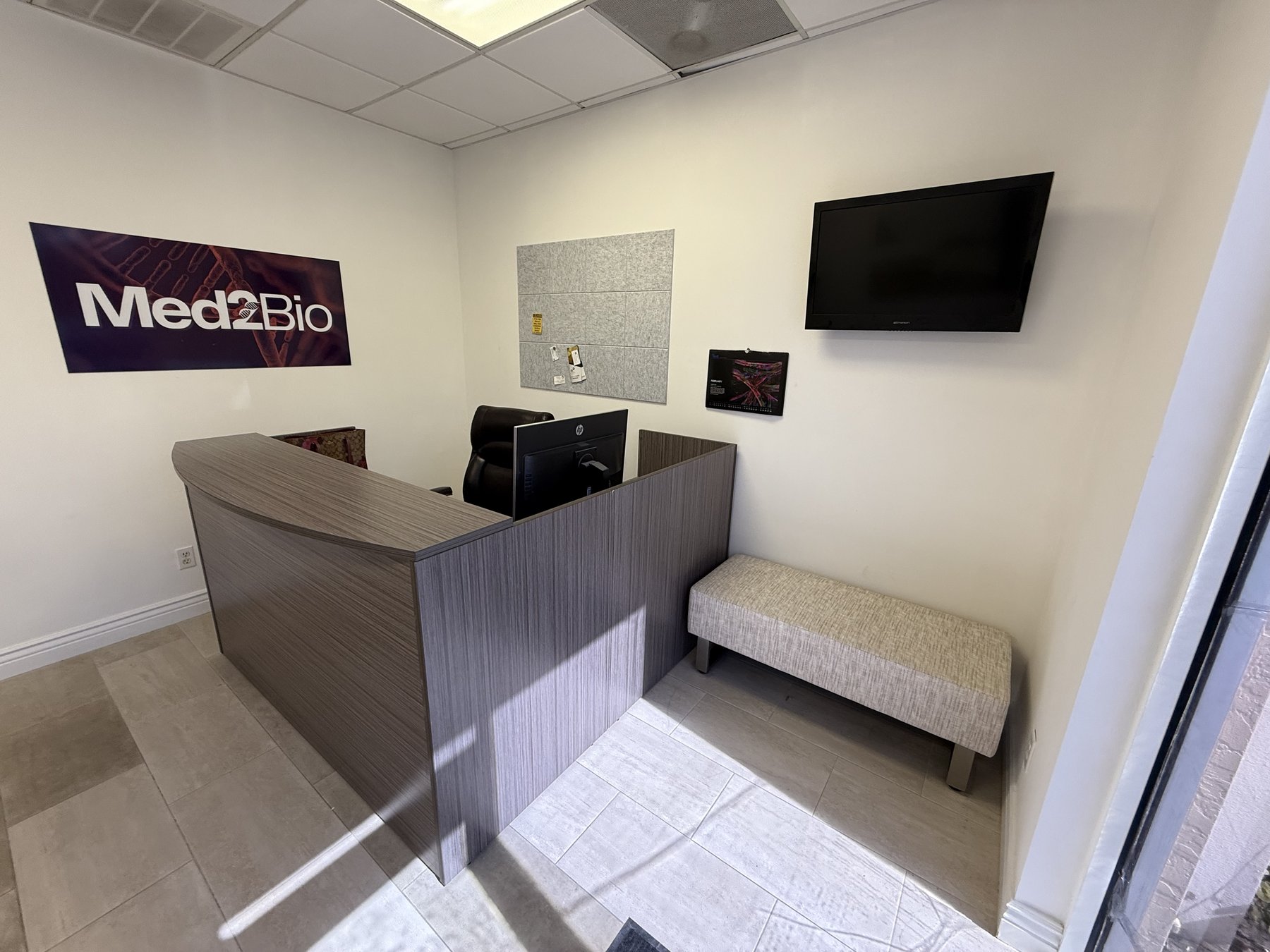 Med2Bio reception desk with Med2Bio branding