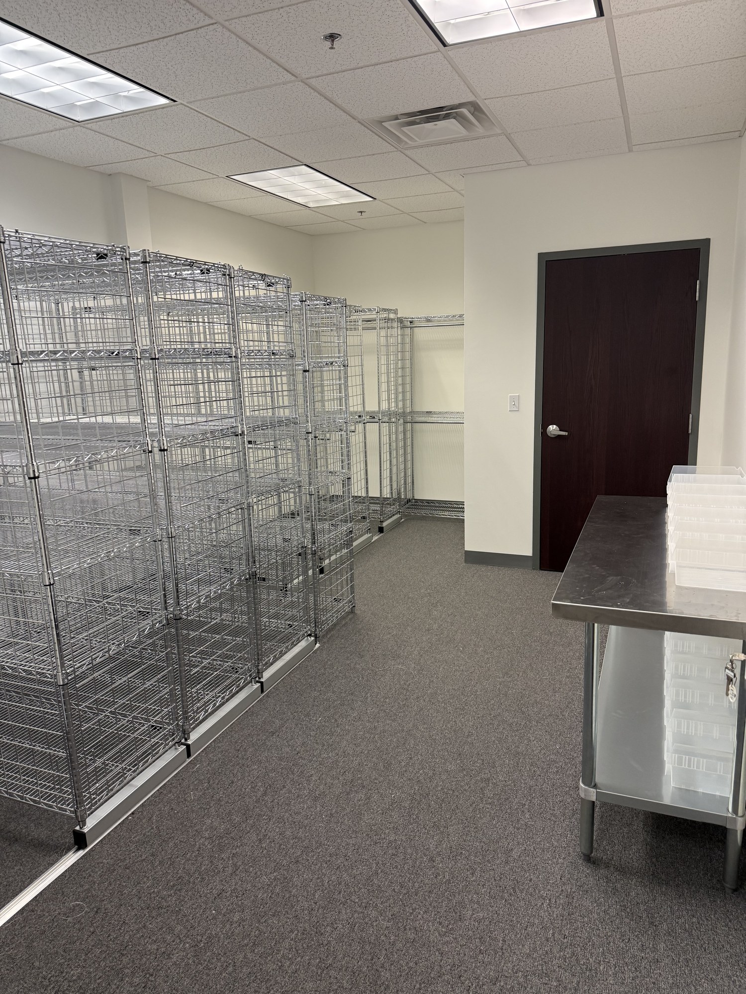 Full room view showing racks, door, and work table