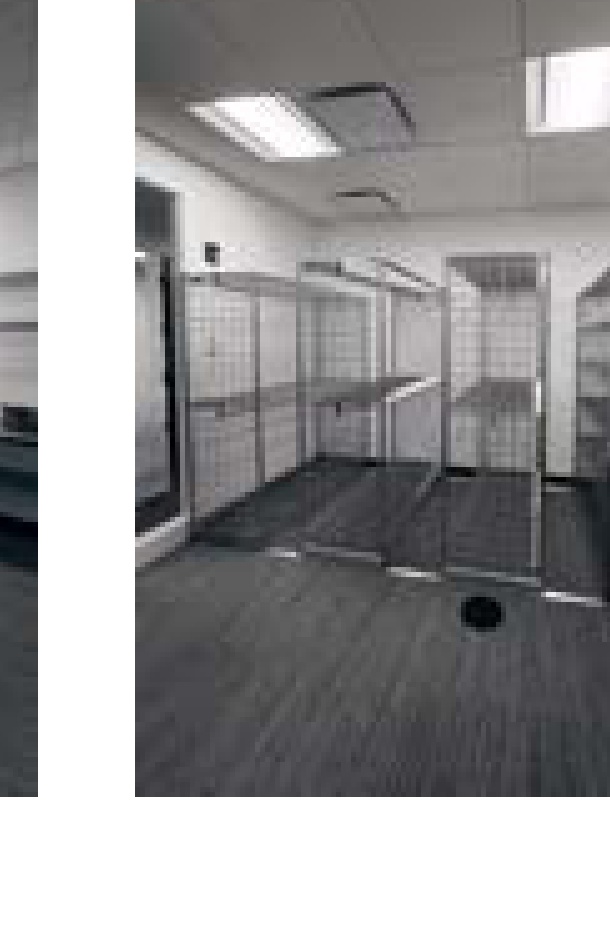 Westborough storage room overview with garment racks and work table